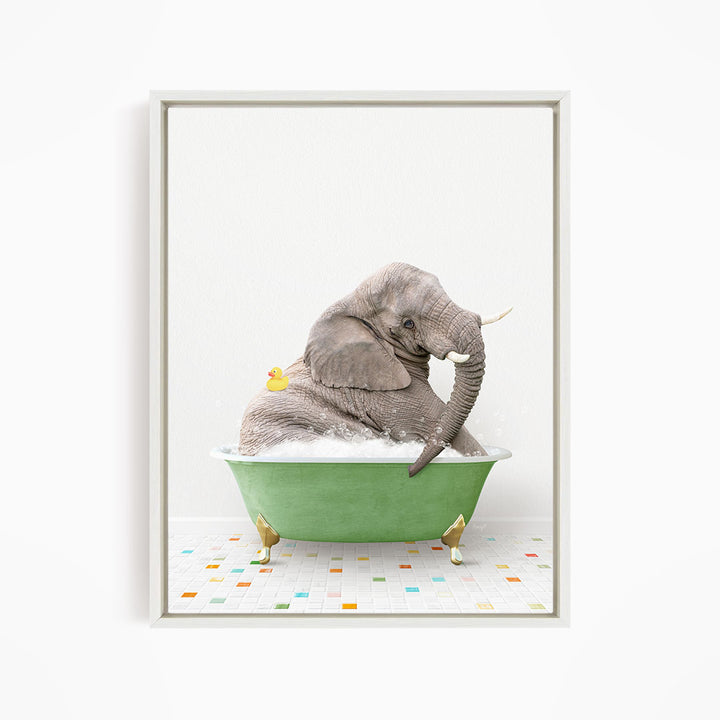 A gray elephant is sitting in a green bathtub, with a yellow duck perched on its back.