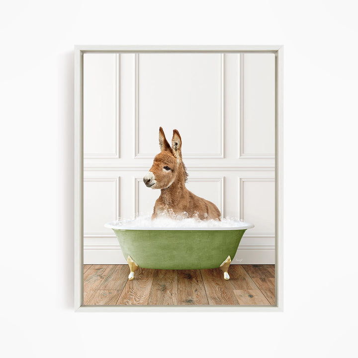 A donkey is sitting in a green bathtub filled with water, looking at the camera.