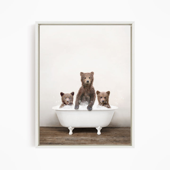 Three adorable brown bears sitting in a white bathtub, enjoying a relaxing bath together.