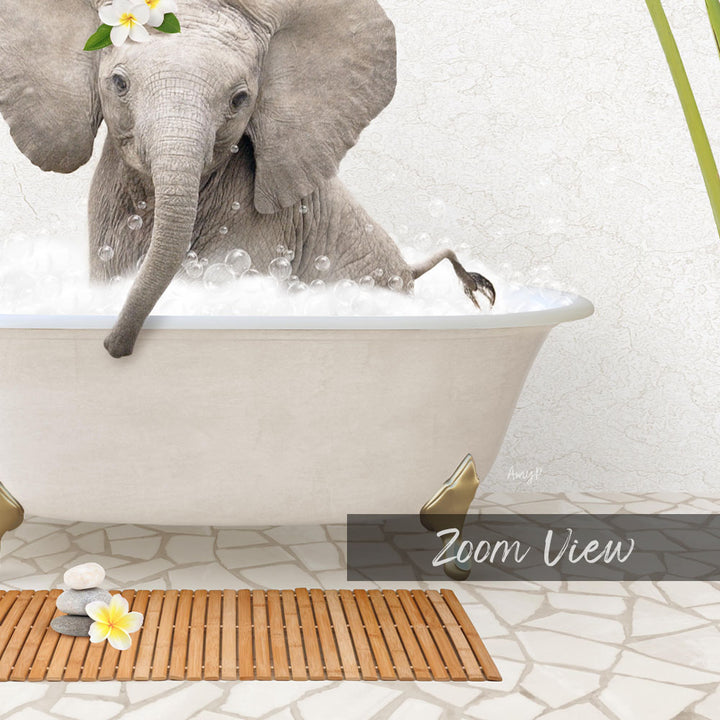 A baby elephant sitting in a bathtub filled with bubbles, surrounded by a wooden mat and a single yellow flower.