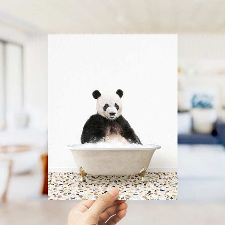 A panda bear sitting in a bathtub filled with bubbles, as if enjoying a relaxing bath.