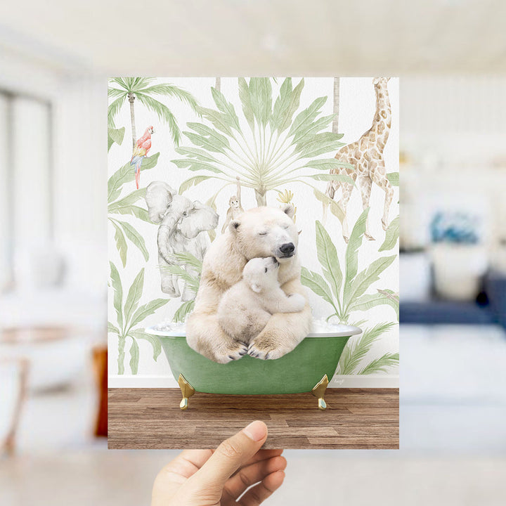 A hand holds up a framed print featuring a polar bear sitting in a bathtub surrounded by tropical plants and animals, including a giraffe and elephant.