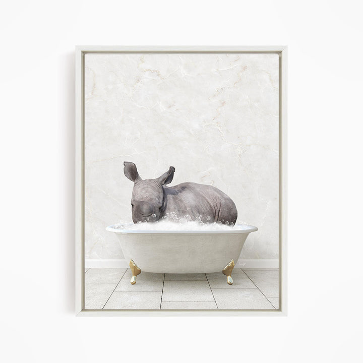 A rhinoceros is sitting in a white bathtub filled with water, creating a whimsical and playful scene.