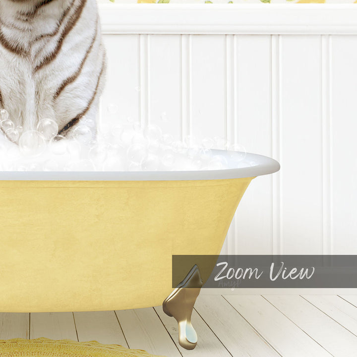 A white and black striped cat is standing in a yellow bathtub filled with bubbles, with a white wall and wooden floor in the background.