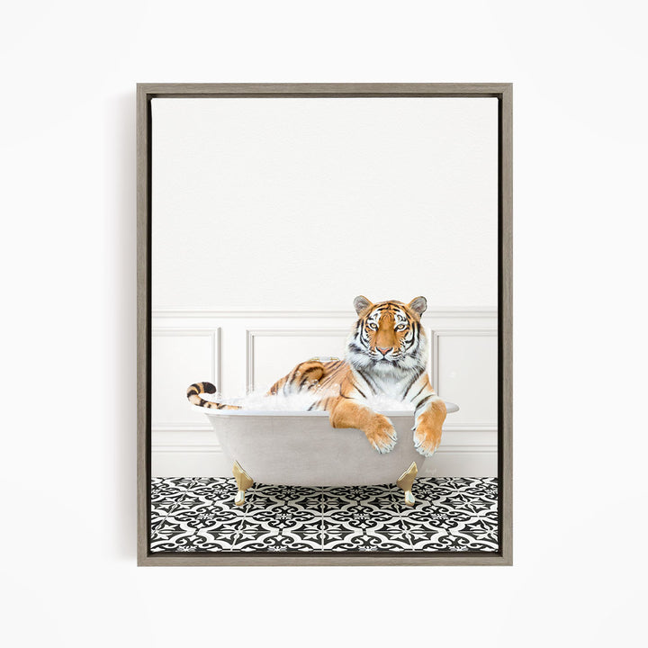 A tiger is sitting in a white bathtub filled with bubbles, resting on a black and white patterned floor.