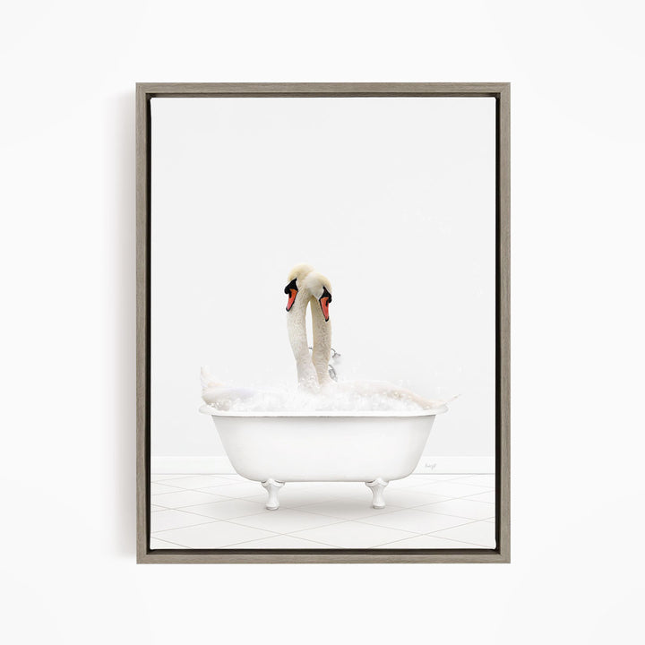 A pair of swans relaxing in a white bathtub against a white background.