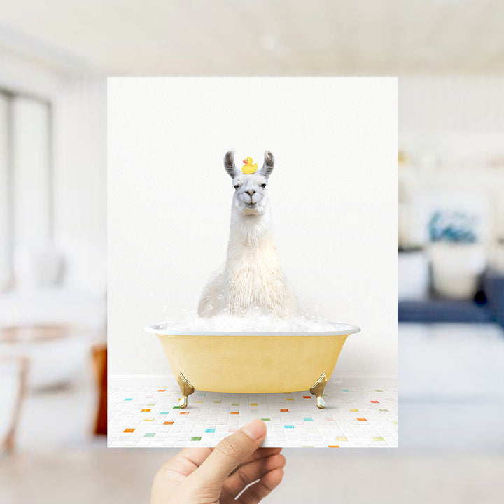 A white llama sitting in a yellow bathtub filled with bubbles, wearing a yellow rubber duck on its head.