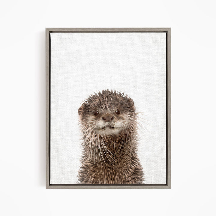 A close-up portrait of an otter with a curious expression, looking directly at the camera.