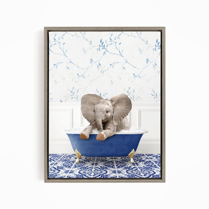 A baby elephant sitting in a blue bathtub, surrounded by a blue and white patterned floor and a floral wallpaper background.