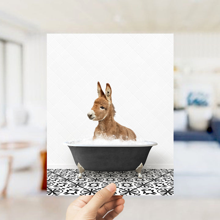 A donkey is sitting in a bathtub filled with water, creating a playful and whimsical scene.