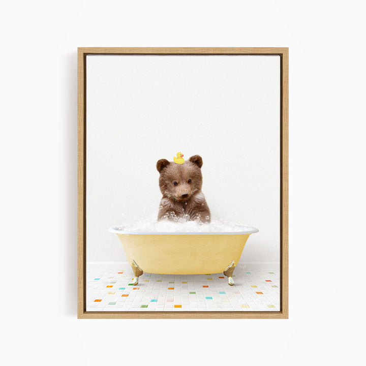 A brown bear sitting in a yellow bathtub filled with bubbles, with a rubber duck perched on its head.
