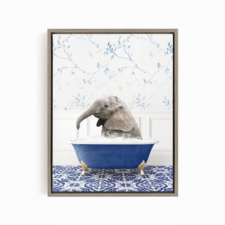 A baby elephant sitting in a blue bathtub filled with water, surrounded by a blue and white patterned rug.