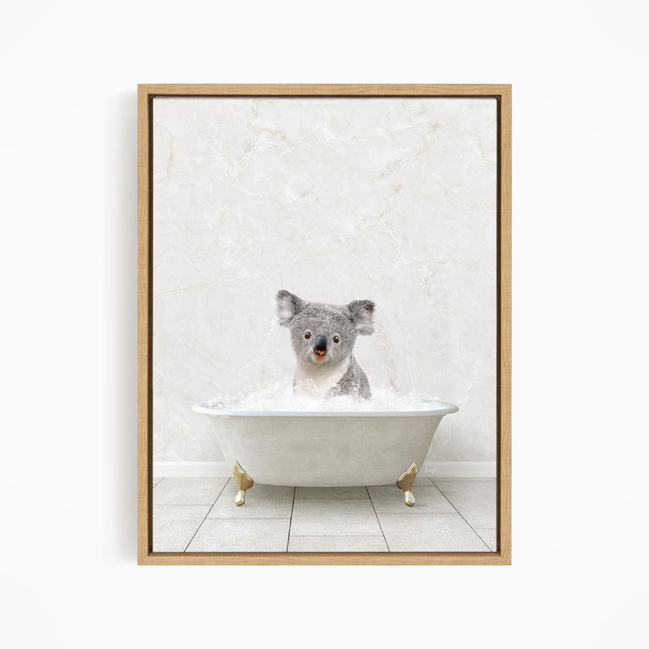 A koala bear sitting in a white bathtub filled with water, looking directly at the camera.