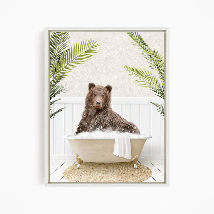 A brown bear sitting in a bathtub filled with water, surrounded by green palm leaves.