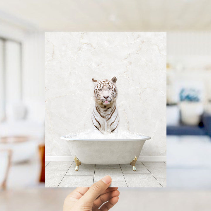 A white tiger sitting in a white bathtub filled with water, with a blurred background suggesting a bathroom setting.
