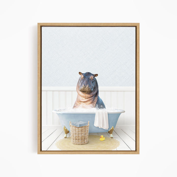 A hippopotamus sitting in a blue bathtub filled with water, surrounded by a basket of rubber ducks and a towel.