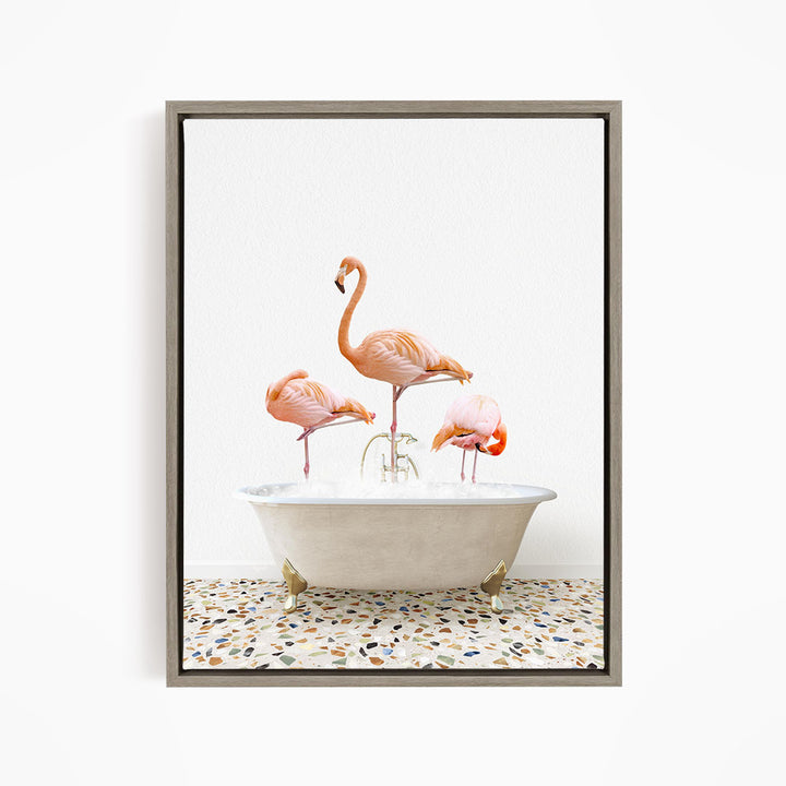 A framed image depicting three pink flamingos standing in a white bathtub filled with water.