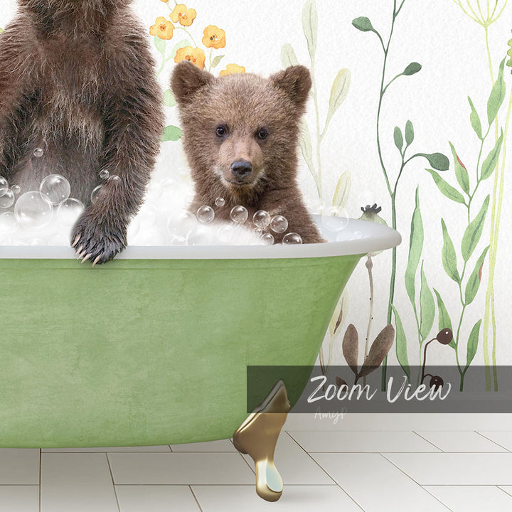 A young bear cub sitting in a green bathtub filled with bubbles, surrounded by a floral wallpaper.