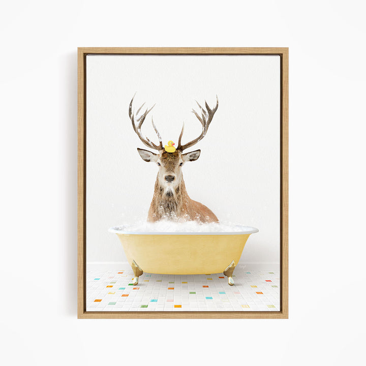 A deer with antlers is sitting in a yellow bathtub filled with bubbles, with a rubber duck perched on its head.