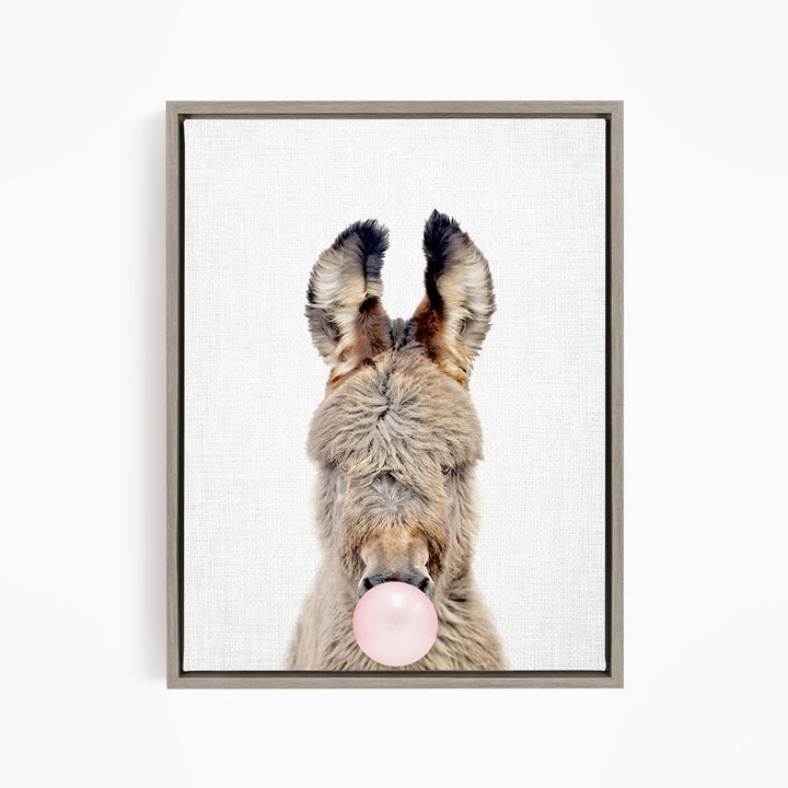 A donkey blowing a bubble with a pink bubble gum bubble.