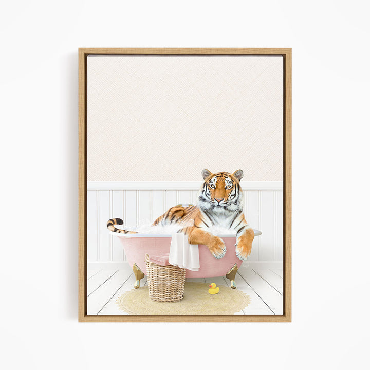 A tiger is sitting in a pink bathtub filled with water, surrounded by rubber ducks.