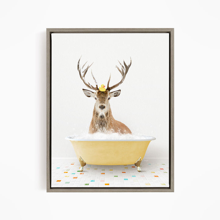 A deer with antlers is sitting in a yellow bathtub filled with bubbles, with a rubber duck perched on its head.