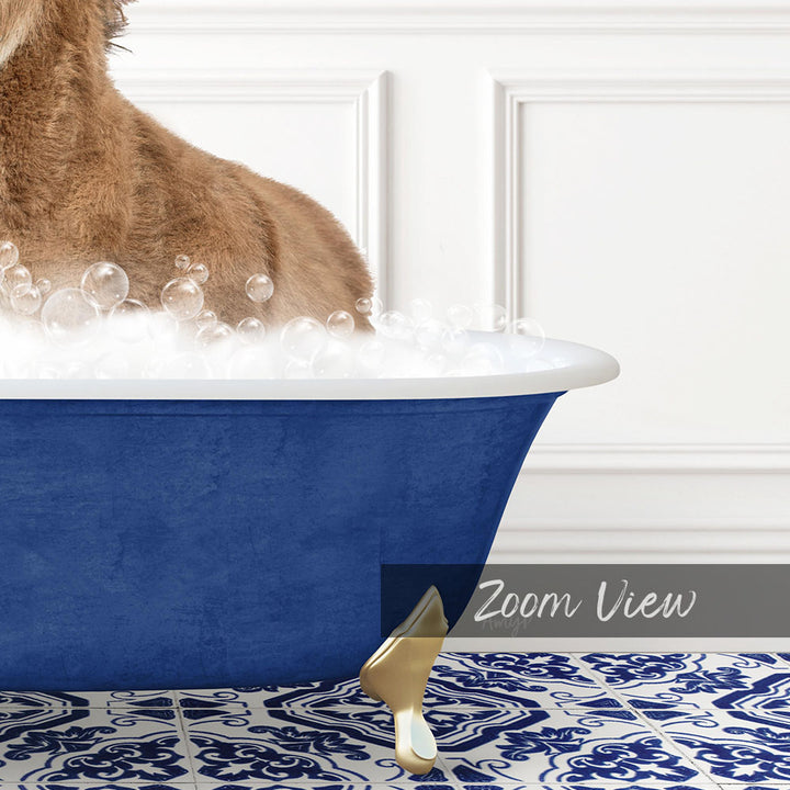 A dog is standing in a blue bathtub filled with bubbles, with a gold claw-like object on the floor next to the tub.