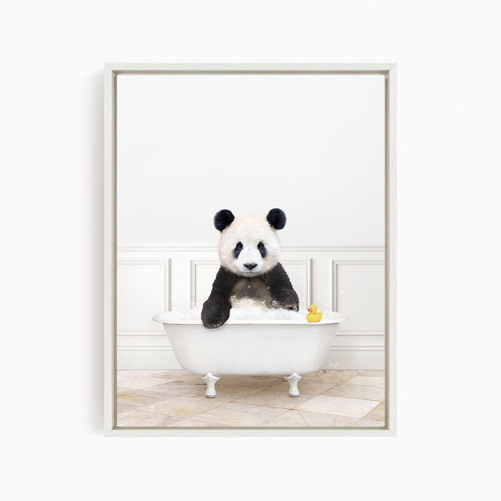 A panda bear sitting in a white bathtub, with a rubber duck floating in the water.