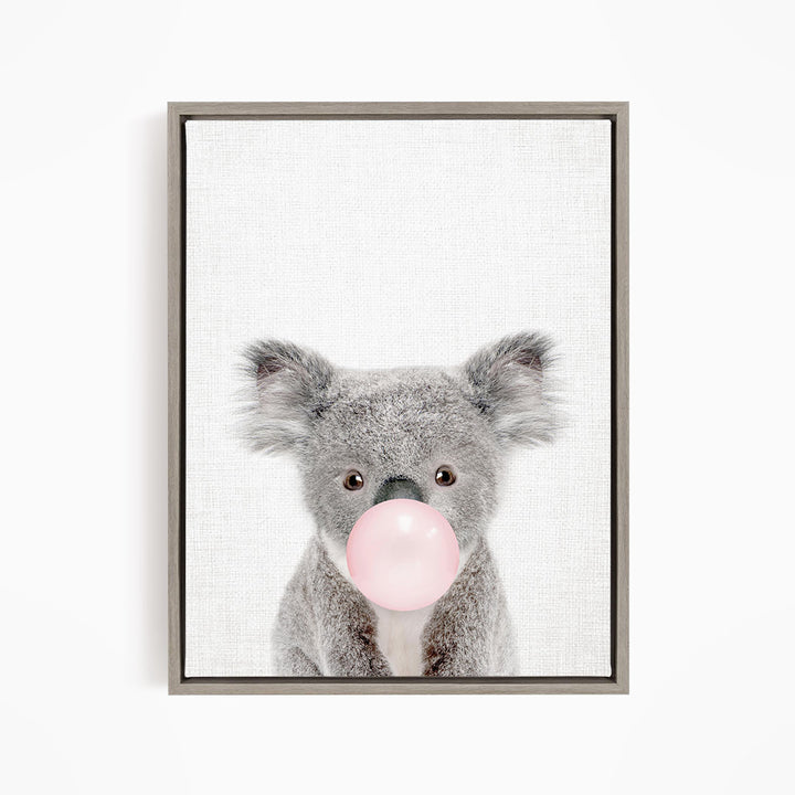 A cute koala bear blowing a bubble with a pink bubble gum bubble.