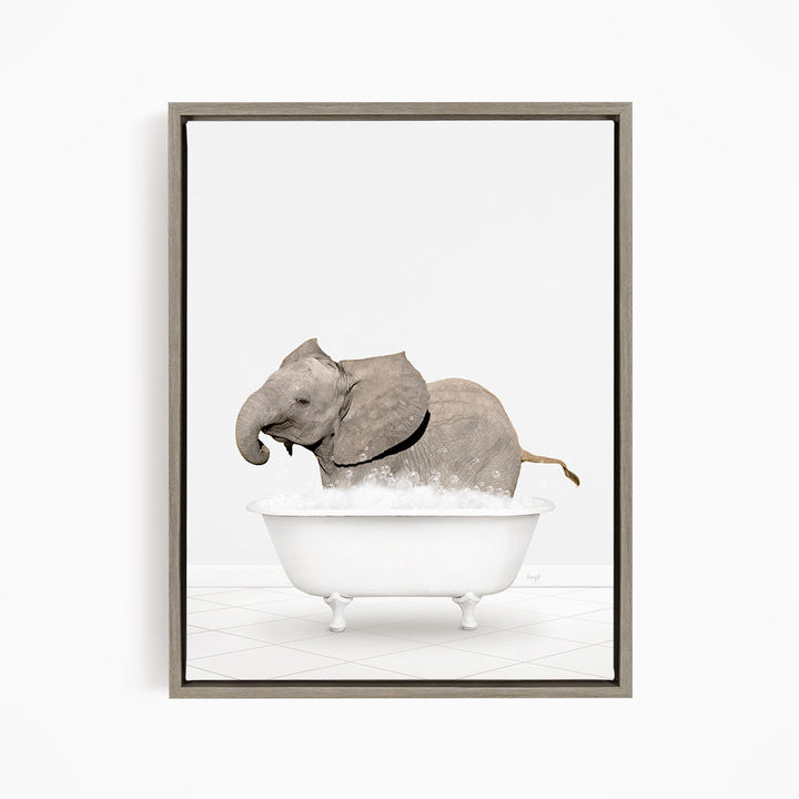 A gray elephant is standing in a white bathtub filled with bubbles, creating a whimsical and playful scene.