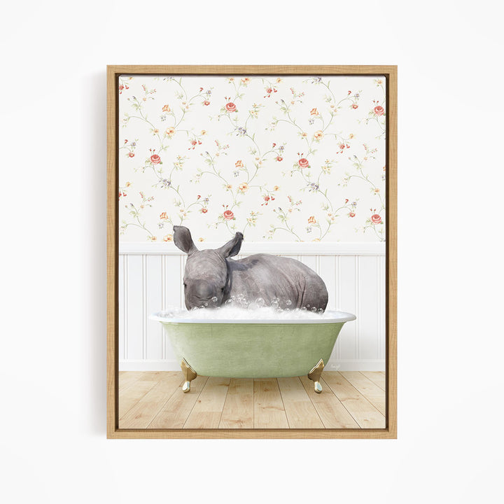 A rhinoceros is sitting in a green bathtub, surrounded by a floral wallpaper.