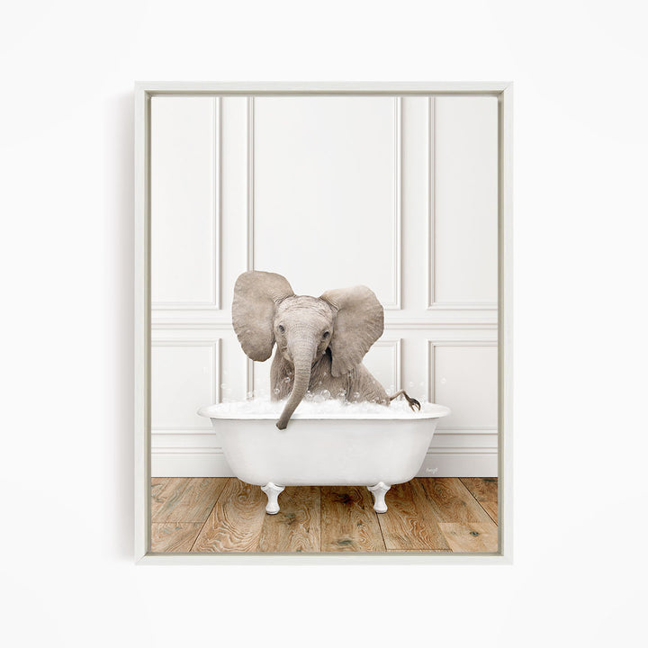 A baby elephant sitting in a white bathtub filled with water, with its trunk submerged in the water.