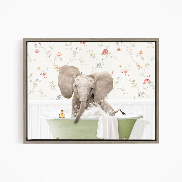A gray elephant is sitting in a green bathtub filled with bubbles, surrounded by a floral wallpaper.