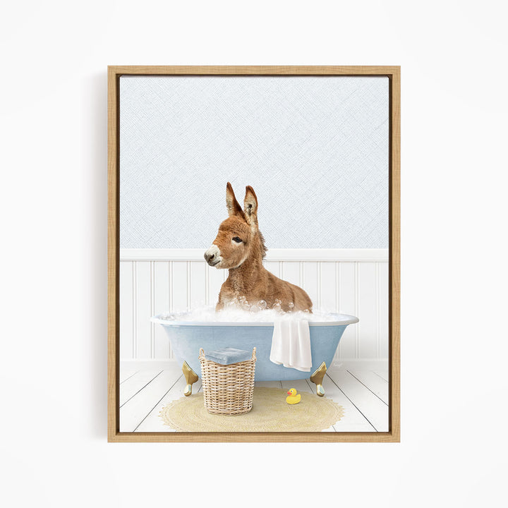 A donkey is sitting in a blue bathtub filled with water, surrounded by rubber ducks.