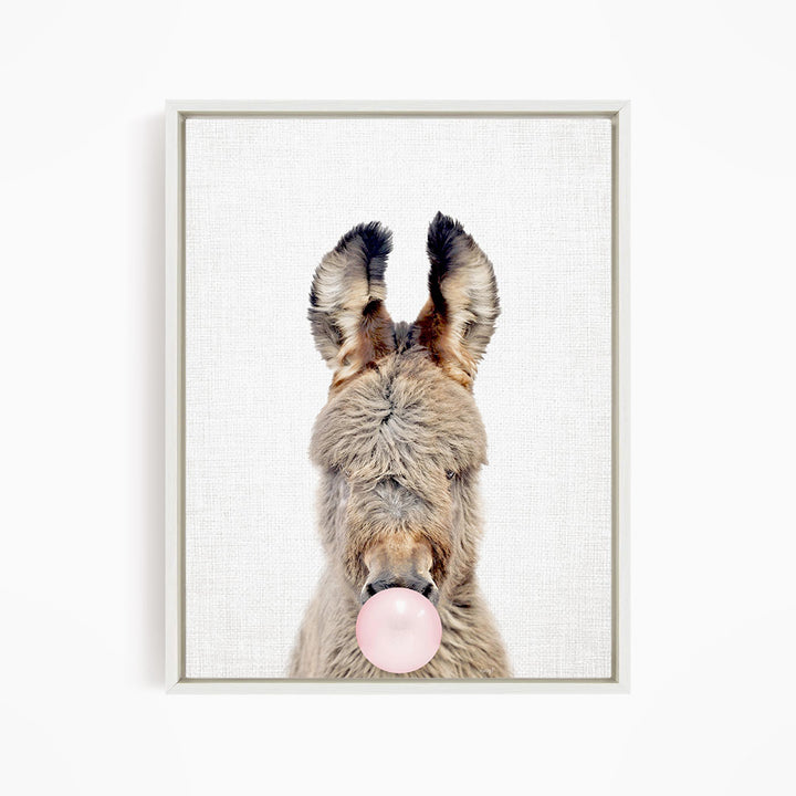 A donkey blowing a bubble with a pink bubble gum bubble.