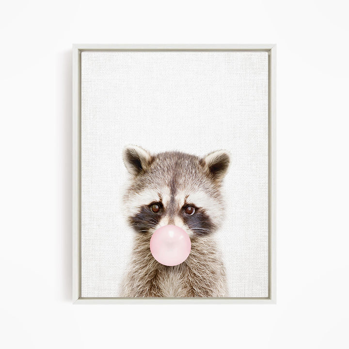 A raccoon blowing a bubble with a pink bubble gum bubble.