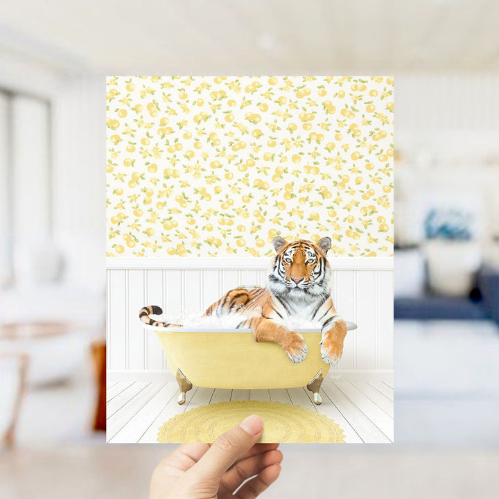 A tiger is sitting in a yellow bathtub, surrounded by a yellow and white floral pattern on the wall behind it.