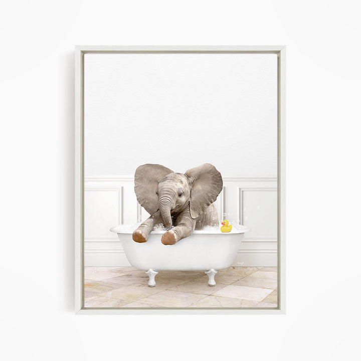 A baby elephant sitting in a white bathtub, with a rubber duck floating nearby.