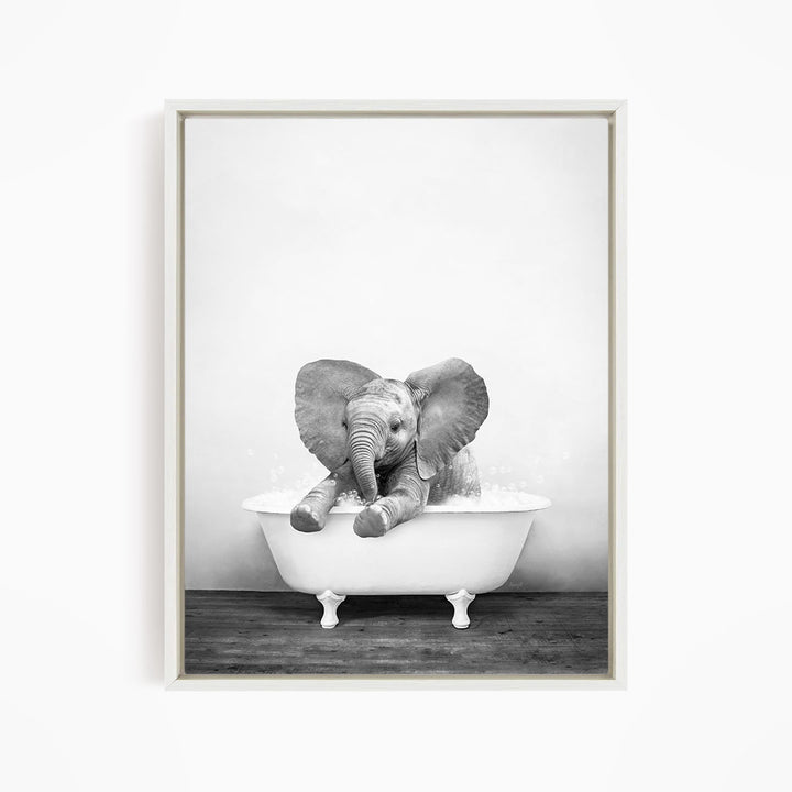 A baby elephant sitting in a bathtub filled with water, enjoying a bath.