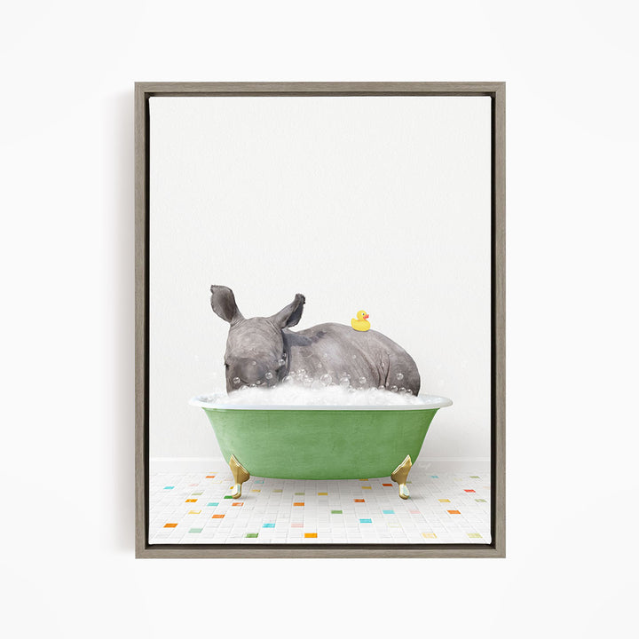 A rhinoceros is sitting in a green bathtub filled with bubbles, with a yellow rubber duck floating on its back.