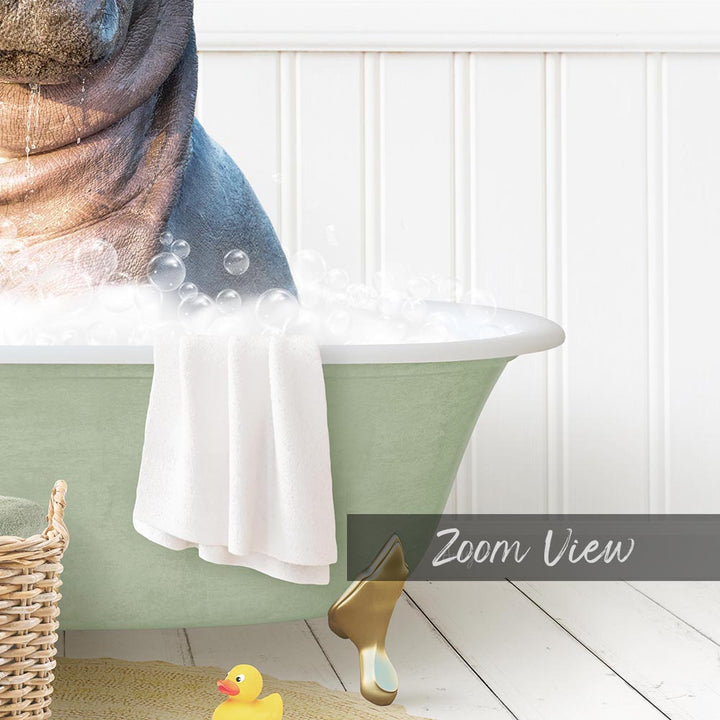 A bathtub filled with bubbles, with a towel hanging over the side and a rubber duck nearby.