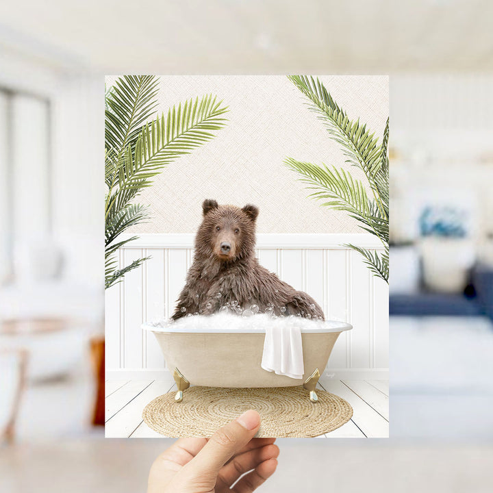 A brown bear sitting in a bathtub filled with bubbles, surrounded by green palm leaves, creating a whimsical and playful scene.