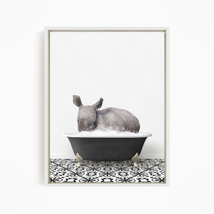 A rhinoceros is sitting in a bathtub filled with water, creating a whimsical and playful scene.
