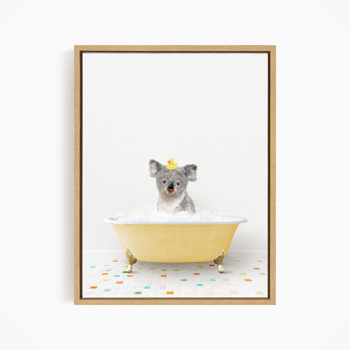 A koala bear sitting in a yellow bathtub filled with bubbles, wearing a yellow rubber duck hat.
