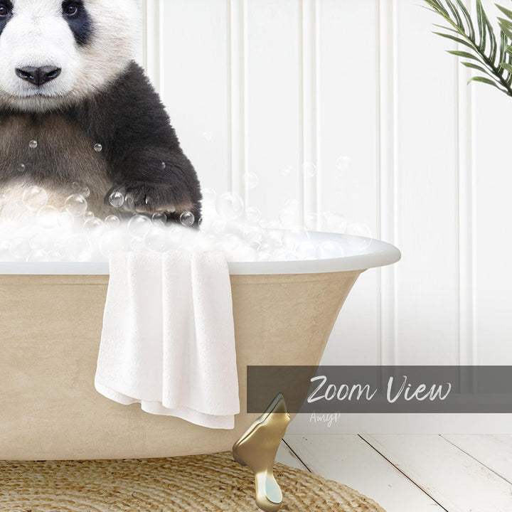 A panda bear sitting in a bathtub filled with bubbles, with a towel and a gold object nearby.