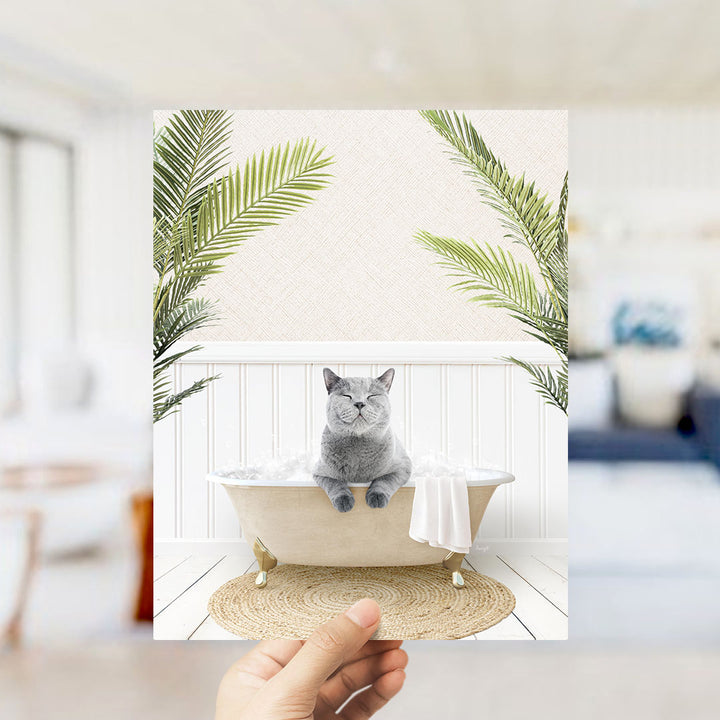 A gray cat sitting in a bathtub filled with bubbles, surrounded by green palm leaves, creating a whimsical and relaxing scene.