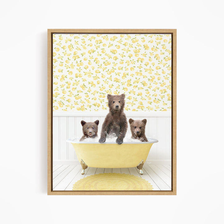 A framed image depicting three bears sitting in a yellow bathtub, with a yellow floral wallpaper in the background.