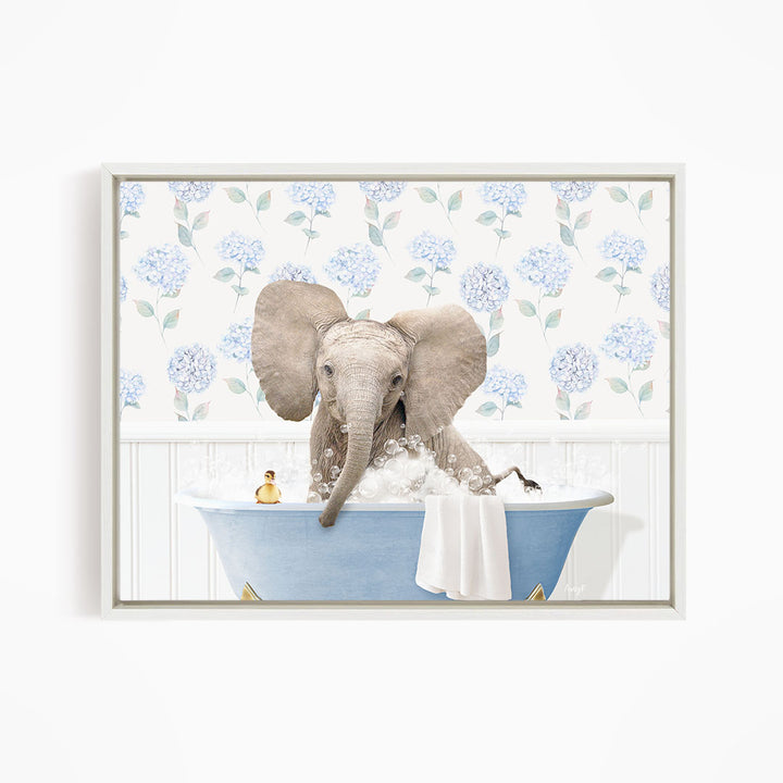 A gray elephant is sitting in a blue bathtub filled with water, surrounded by a floral patterned wall.