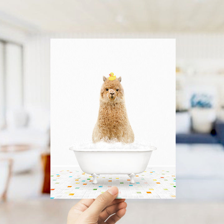 A fluffy brown dog sitting in a white bathtub filled with bubbles, wearing a yellow rubber duck hat.