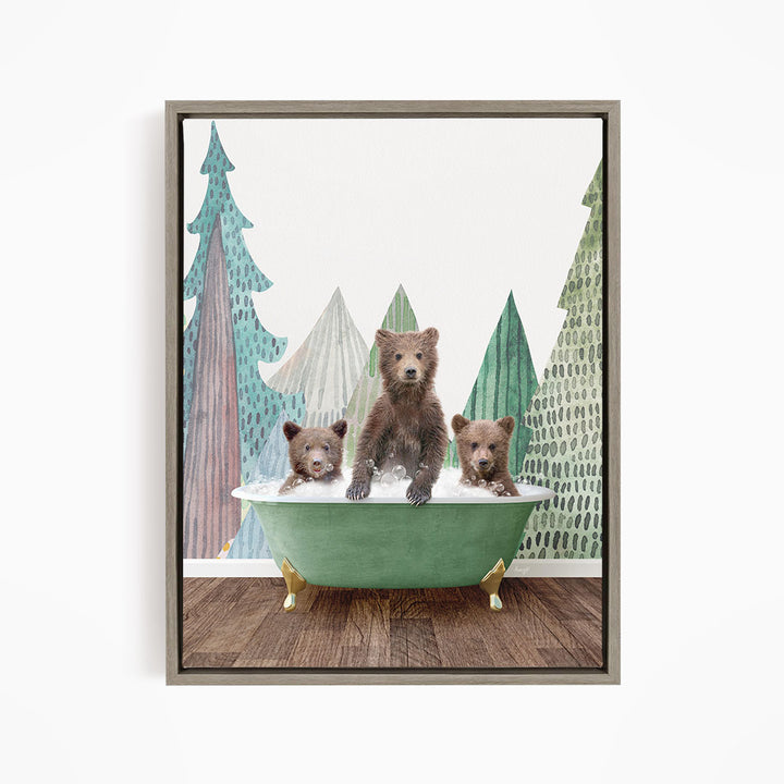 A framed image depicting three bears sitting in a green bathtub, surrounded by a forest scene with trees and a blue sky.